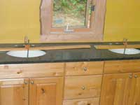 Countertop in the master bath, with undermount sinks in the process of being attached